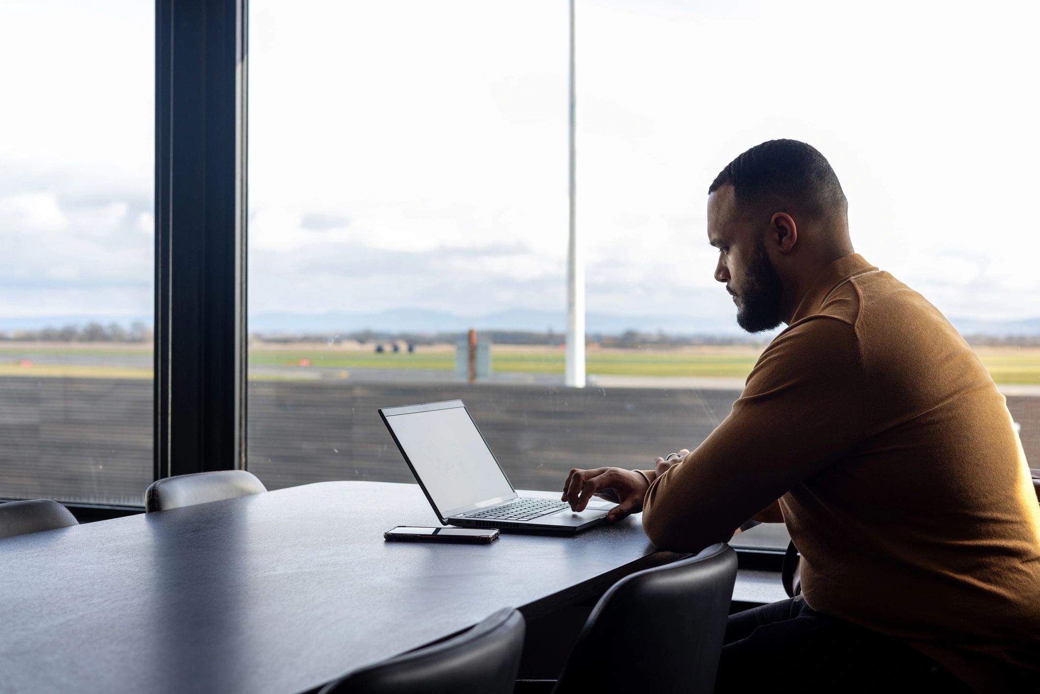 Person using a laptop to review plans and resources